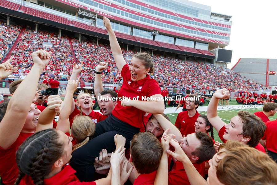Sophia Kallas of Green Bay, Wisconsin, is carried aloft after the junior mellophone player won the march off competition at the Cornhusker Marching Band Exhibition. August 17, 2018. Photo by Craig Chandler / University Communication.