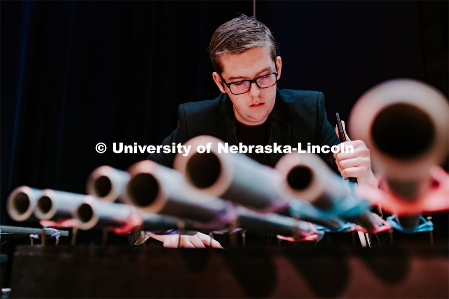Andrew Wray using a bow on some metal pipes, Percussion Ensemble rehearsal. August 17, 2018. Photo by Justin Mohling / University Communication.