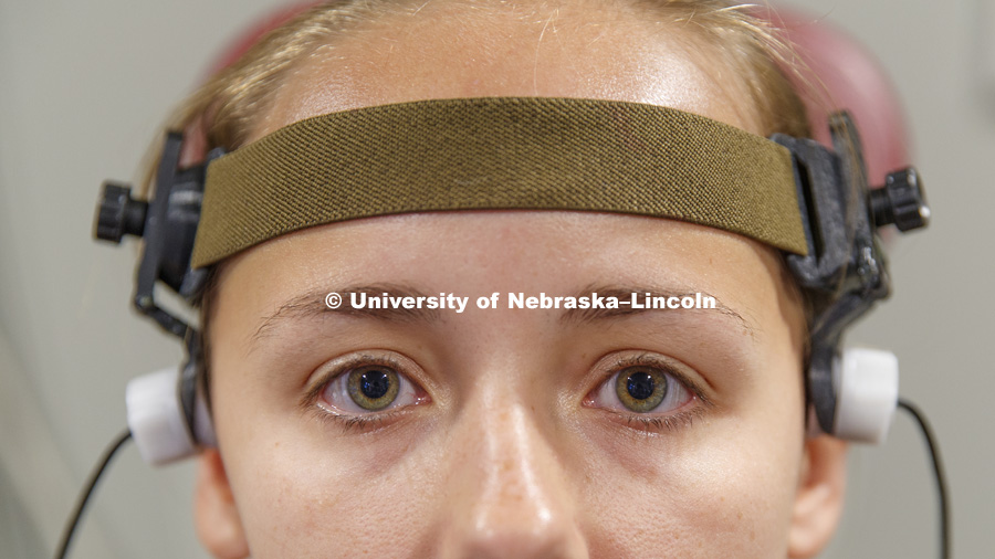 Graduate student Elizabeth Hoffman wears a headband with the Doppler transducers to record her reactions to the stimuli. Nebraska researchers Steven Barlow and Greg Bashford have developed a system to treat stroke victims using a functional transcranial Doppler ultrasound and somatosensory stimulation. The stimulation has been shown in animal models to provide neuroprotection. The technology could prevent brain death. August 23, 2018. Photo by Craig Chandler / University Communication.