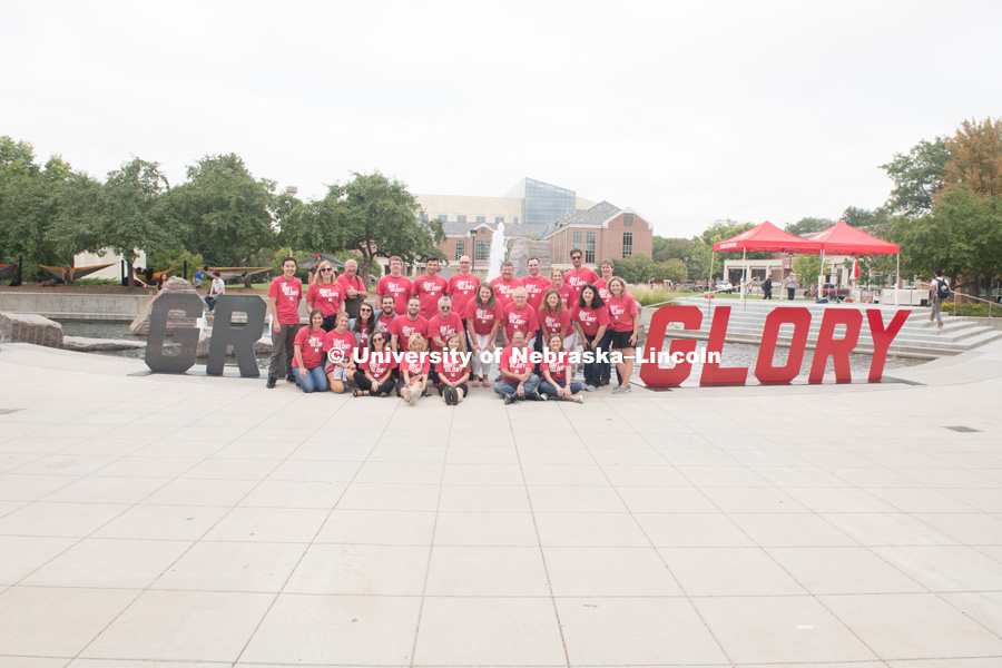 The University Communication group poses for a picture in front of the Broyhill Fountain by the Grit and Glory signs. In Our Grit, Our Glory brand reveal party on city campus at the Nebraska Union. August 30, 2018. Photo by Greg Nathan, University Communication.