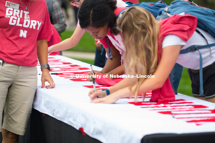 Everyone was asked to sign on a banner what girt and glory meant for them. In Our Grit, Our Glory brand reveal party on east campus at the Nebraska Union. August 31, 2018. Photo by Greg Nathan, University Communication.