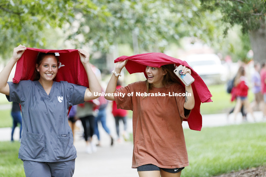 Leah Sackschewski and Katie Whittaker found quick use of their new In Our Grit, Our Glory brand reveal party on east campus at the Nebraska Union. August 31, 2018. Photo by Craig Chandler / University Communication.