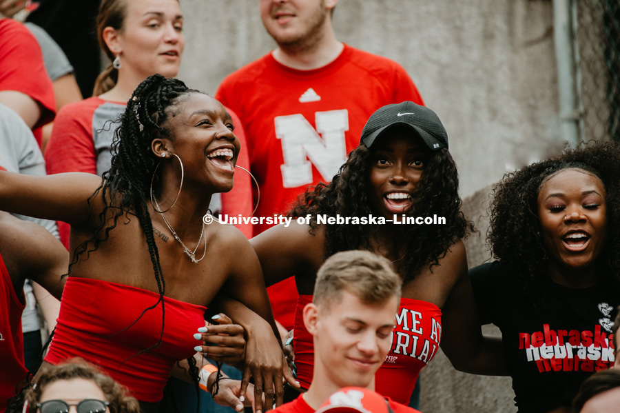 3 students dancing to a song over the loudspeaker at the Nebraska vs. Colorado football game in Memorial Stadium. September 8, 2018. Photo by Justin Mohling / University Communication.
