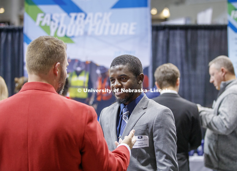 Messangan Agbozo talks with an Union Pacific recruiter at the STEM Career Fair (Science, Technology, Engineering, and Math) in Pinnacle Bank Arena. September 25, 2018. Photo by Craig Chandler / University Communication.