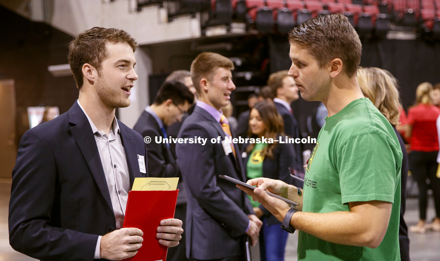 Drew Jerred talks with a John Deere recruiter at the STEM Career Fair (Science, Technology, Engineering, and Math) in Pinnacle Bank Arena. September 25, 2018. Photo by Craig Chandler / University Communication.