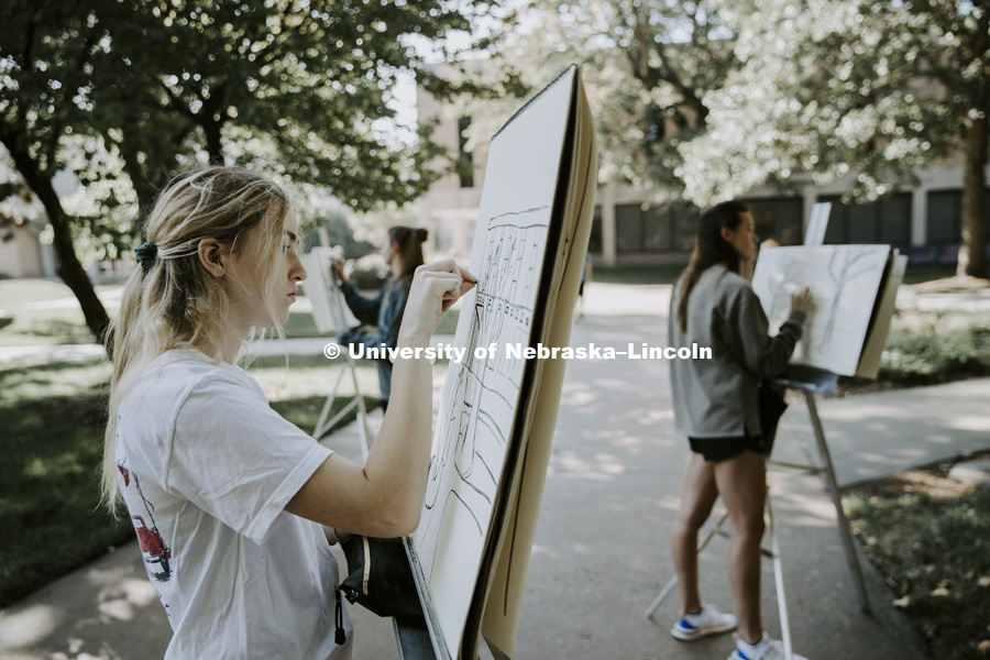 Elizabeth Kramer from Gretna, Nebraska, works on her drawing. DSGN120 Design Drawing students work with instructor Chip Stanley as they draw outside Architecture Hall. October 3, 2018. Photo by Craig Chandler / University Communication.