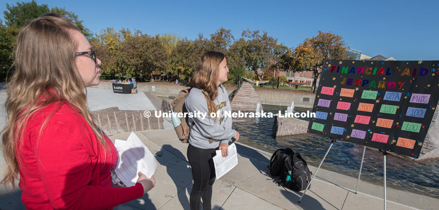 Tabitha Haynes, from the Scholarships and Financial Aid department plays Financial Aid Jeopardy with student, Tina Blaser outside the Nebraska Union on City Campus. October 17, 2018. Photo by Gregory Nathan, University Communication.