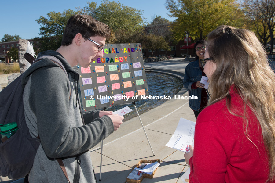 Tabitha Haynes, from the Scholarships and Financial Aid department plays Financial Aid Jeopardy with students Dalia Chavez and Cory Meyer outside the Nebraska Union on City Campus. October 17, 2018. Photo by Gregory Nathan, University Communication.