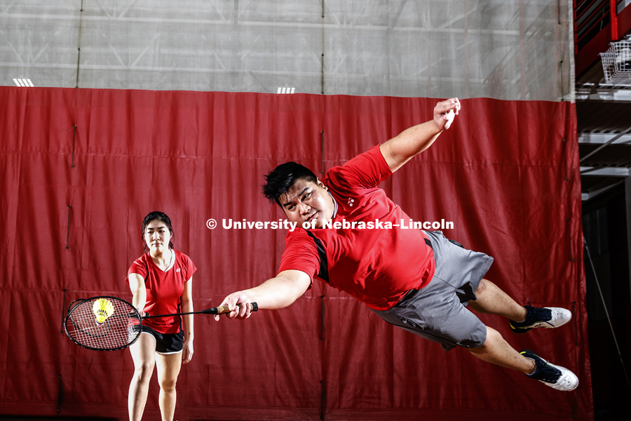 Frederick Chua is a junior business management student at the College of Business, and president of the badminton club, dives as Poh Ling Lim backs up his dive. October 24, 2018. Photo by Craig Chandler / University Communication.