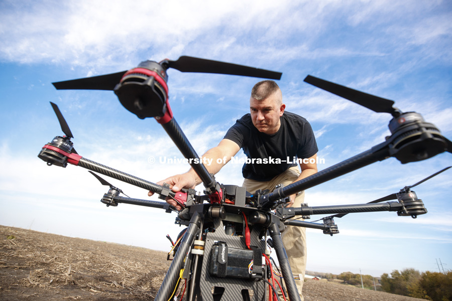Nebraska's Adam Plowcha, graduate student in computer science and Navy veteran, pilots a large UACV drone that is being developed to drill holes and place sensors in soil. The vehicle has multiple applications, from agriculture to national defense. October 26, 2018. Photo by Craig Chandler / University Communication.