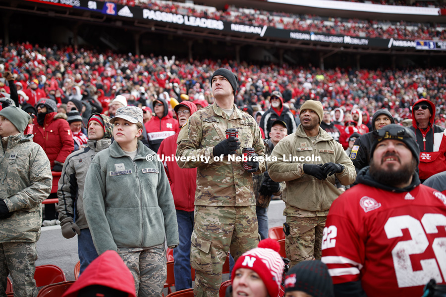 Air Force National Guard Airman First Class Alica Buchhousen, Army National Guard Cpl. Andrew Hubbell and Air Force National Guard Tech. Sgt. Terrance Smith watch the game from an area in between east stadium seats and the bench area reserved for active duty military members and veterans. Nebraska vs. Illinois football in Memorial Stadium. November 10, 2018. Photo by Craig Chandler / University Communication.