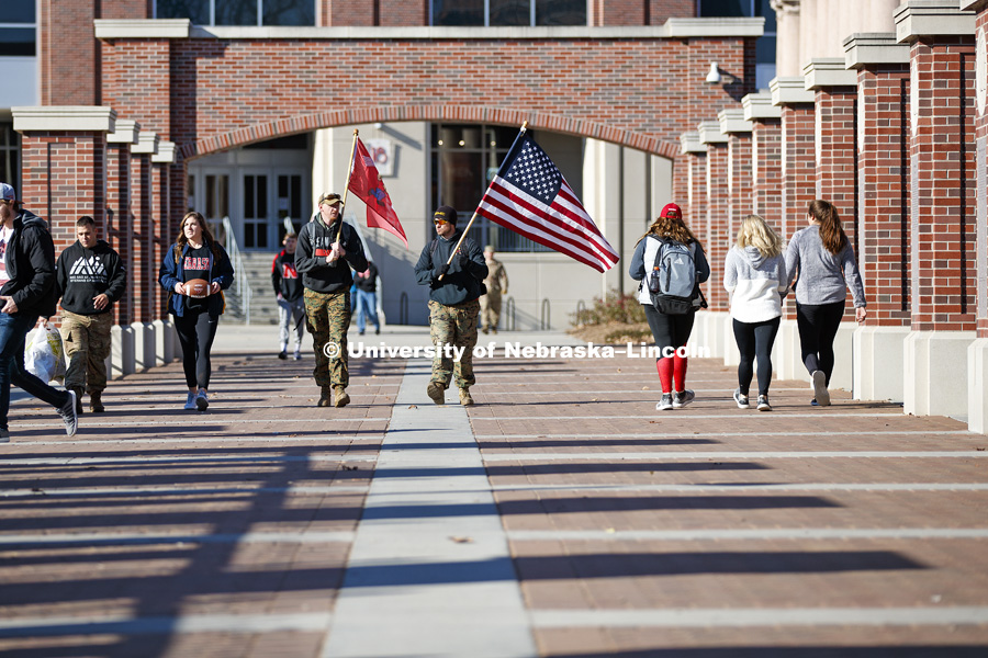 Army veteran Jared Collins, undergraduate Natalie Kraft, a Navy veteran, undergraduate and Marine veteran Jake Post and Jerod Post, '13 and a Marine veteran, begin their march to Iowa City. Beginning of veterans Ruck March, which uses Nebraska and Iowa veterans to carry the game ball from Lincoln to Iowa City. November 14, 2018. Photo by Craig Chandler / University Communication.