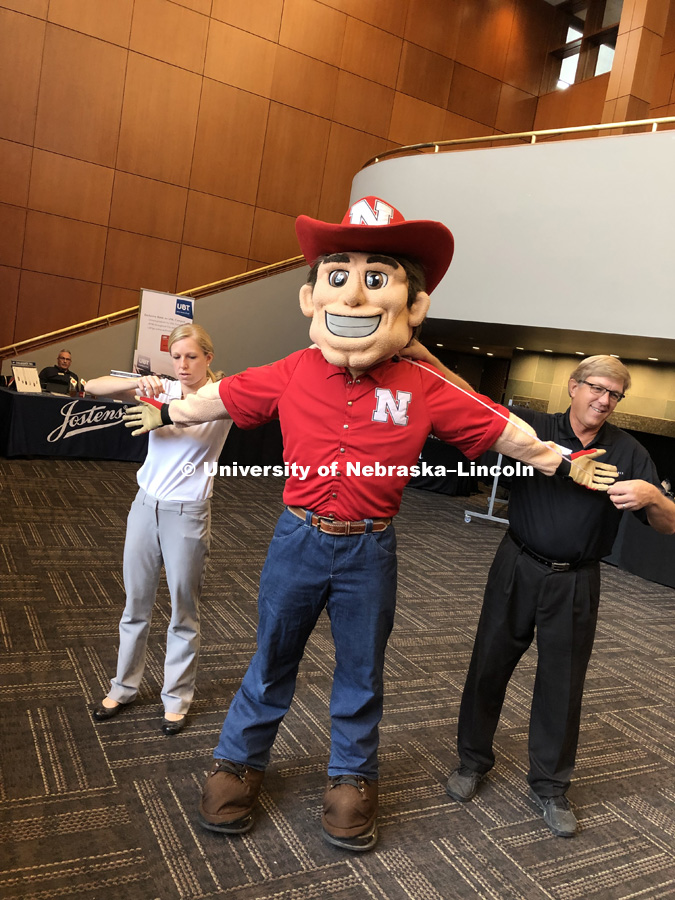 Herbie Husker being fitted for a graduation gown. November 29, 2018. Photo by Erin Butzke / Husker Athletics