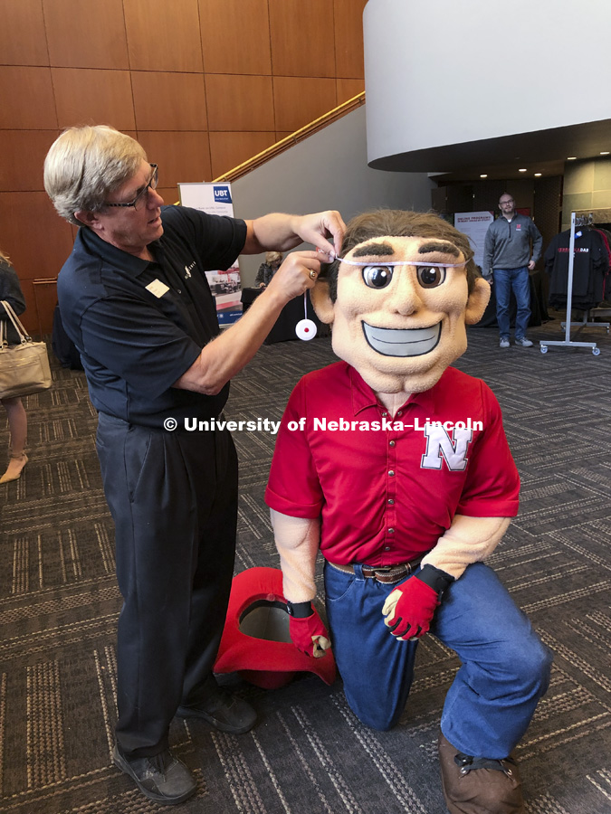 Herbie Husker being fitted for a graduation gown. November 29, 2018. Photo by Erin Butzke / Husker Athletics
