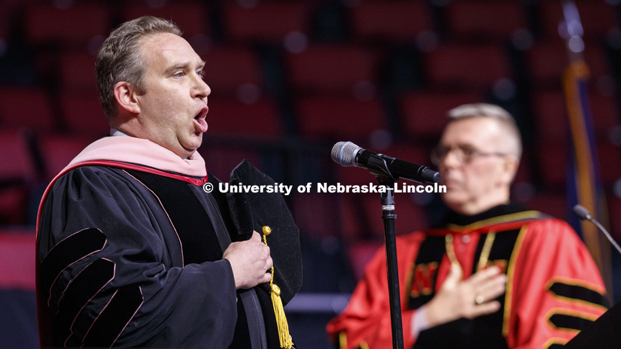 Kevin Hanrahan, Associate Professor of Voice and Vocal Pedagogy, sings the National Anthem at the Graduate Commencement and Hooding in Pinnacle Bank Arena. December 14, 2018. Photo by Craig Chandler / University Communication.