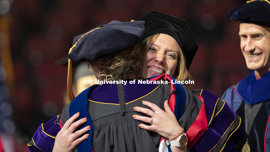 Lori Hoetger, PhD in Psychology, hugs Professor Eve Brank after Hoetger was hooded Friday at the Graduate Commencement and Hooding in Pinnacle Bank Arena. December 14, 2018. Photo by Craig Chandler / University Communication.