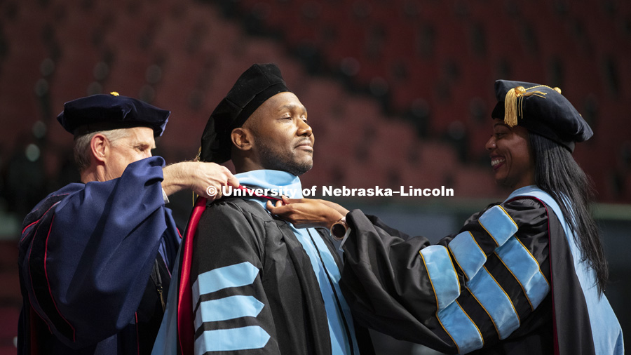 Ivey Brown, Doctor of Education, has his hood placed on his shoulders at the Graduate Commencement and Hooding in Pinnacle Bank Arena. December 14, 2018. Photo by Craig Chandler / University Communication.