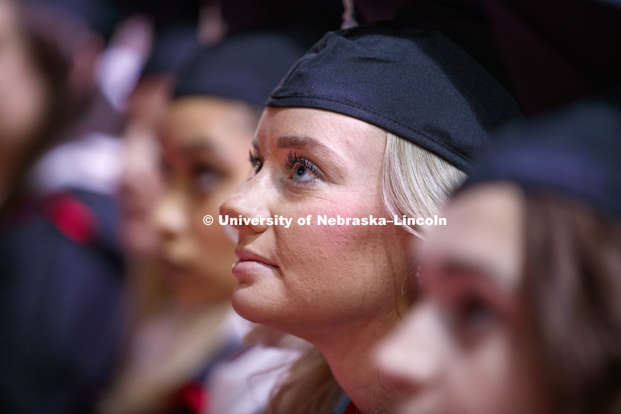Hillary Hotz, Masters in Educational Administration, watches a welcome video from the Nebraska Alumni Association during the Graduate Commencement and Hooding ceremony in Pinnacle Bank Arena. December 14, 2018. Photo by Craig Chandler / University Communication.