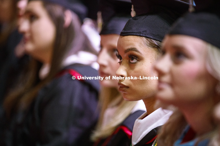 Virginia Hill, Masters in Political Science, watches a welcome video from the Nebraska Alumni Association during the Graduate Commencement and Hooding ceremony in Pinnacle Bank Arena. December 14, 2018. Photo by Craig Chandler / University Communication.