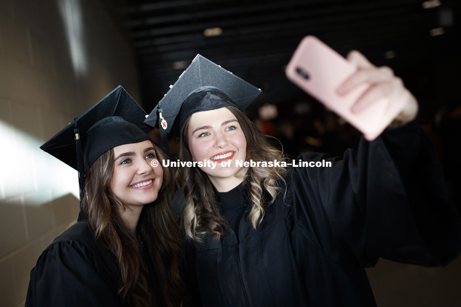 Julia Zoryana and Anastasia Stepanyuk take a selfie before commencement. Undergraduate Commencement in Pinnacle Bank Arena. December 15, 2018. Photo by Craig Chandler / University Communication.