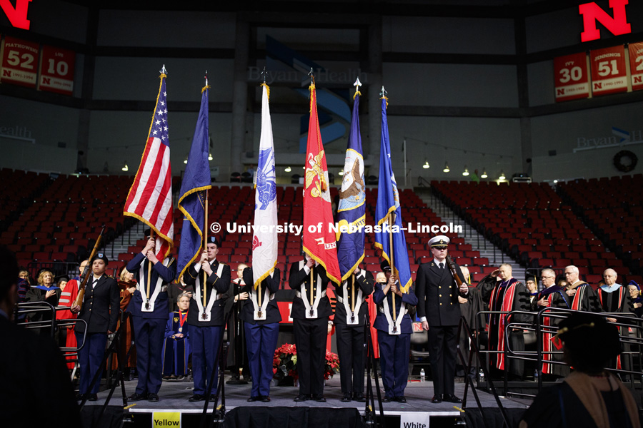 The color guard of the combined ROTC units. Undergraduate Commencement in Pinnacle Bank Arena. December 15, 2018. Photo by Craig Chandler / University Communication.