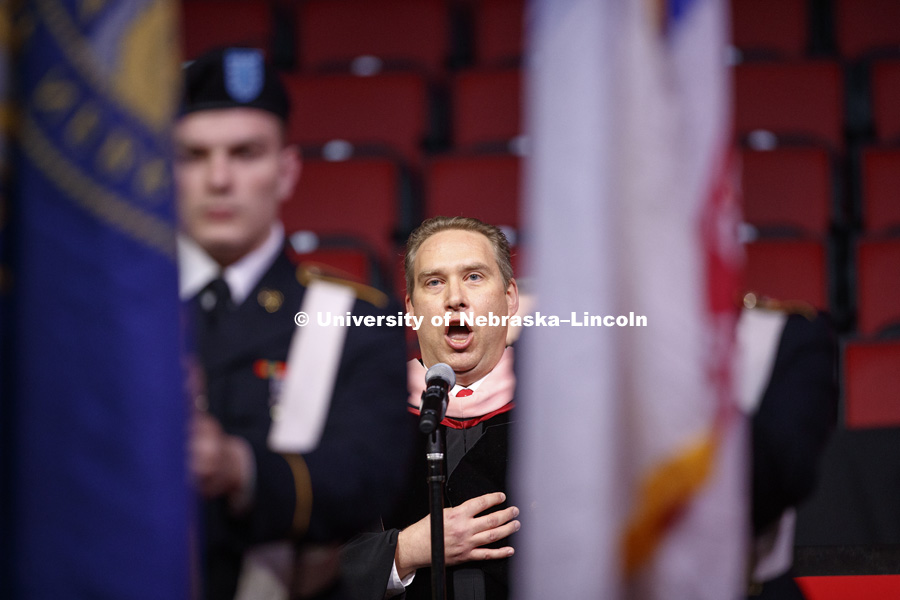 Kevin Hanrahan, Associate Professor of Voice and Vocal Pedagogy, sings the National Anthem at the Undergraduate Commencement in Pinnacle Bank Arena. December 15, 2018. Photo by Craig Chandler / University Communication.