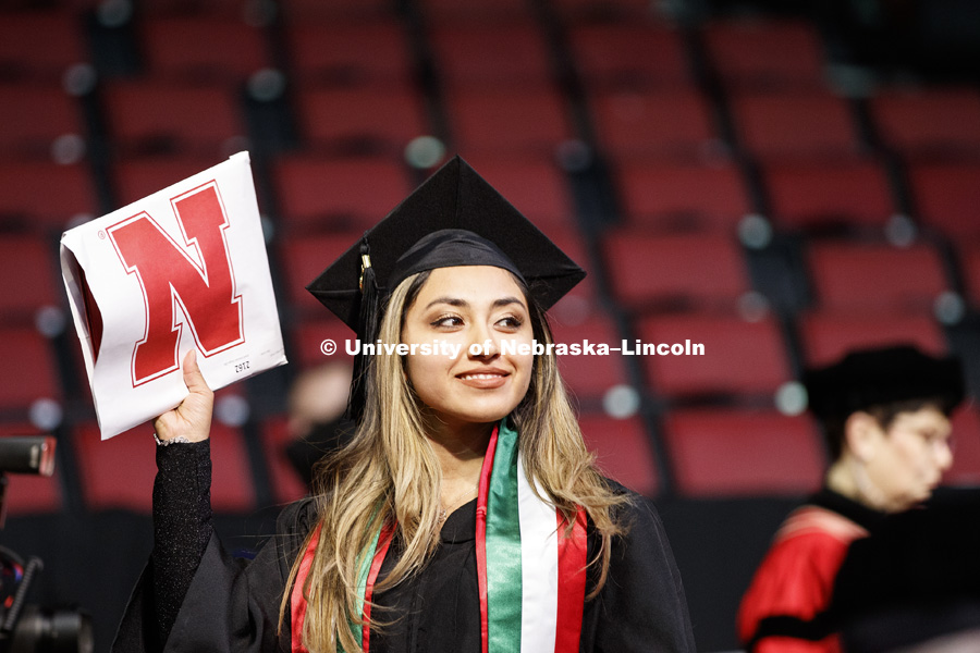 Janelli Sanchez Vargas shows off her diploma for family and friends. Undergraduate Commencement in Pinnacle Bank Arena. December 15, 2018. Photo by Craig Chandler / University Communication.