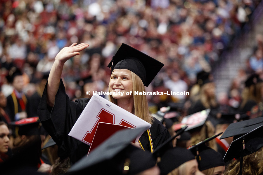 Emma Heldt waves to family and friends at the Undergraduate Commencement in Pinnacle Bank Arena. December 15, 2018. Photo by Craig Chandler / University Communication.