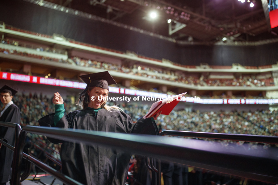 Katerina Marcotte celebrates her new degree as she walks off stage Saturday, at the Undergraduate Commencement in Pinnacle Bank Arena. December 15, 2018. Photo by Craig Chandler / University Communication.