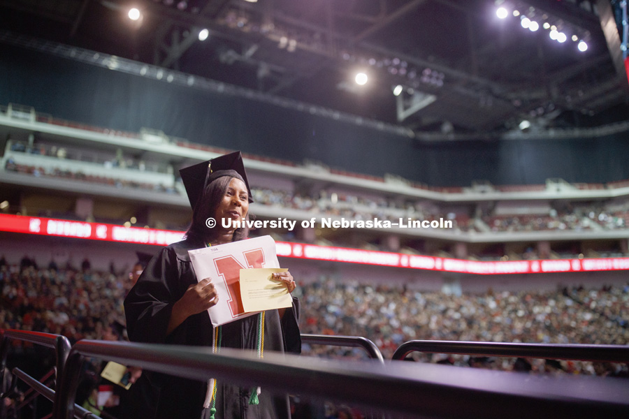 Angel Sumpter walks off stage after receiving her diploma at the Undergraduate Commencement in Pinnacle Bank Arena. December 15, 2018. Photo by Craig Chandler / University Communication.