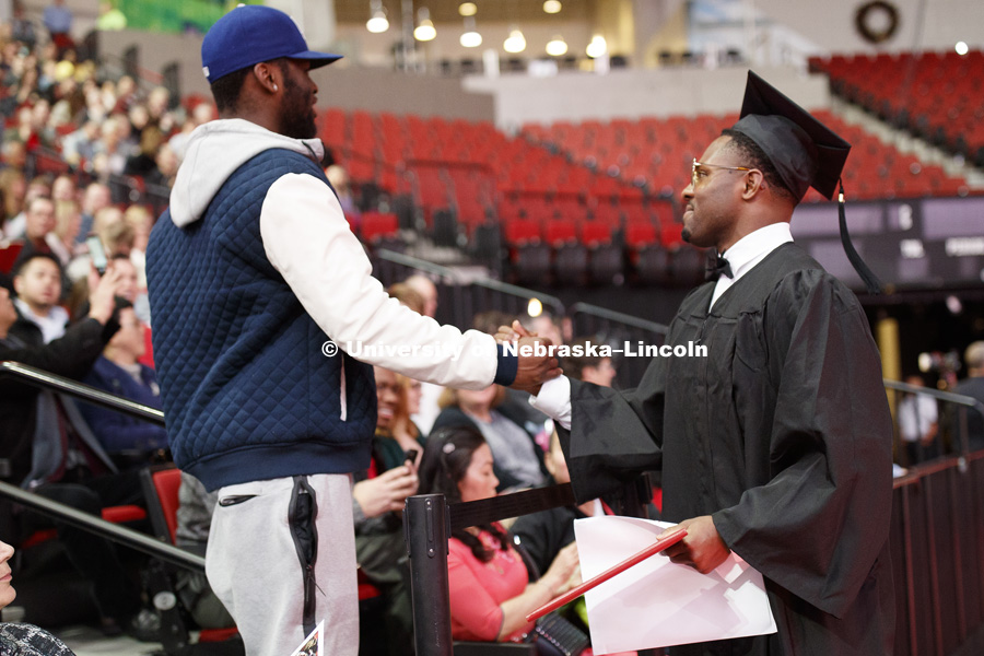 Aaron Williams stops for congratulations on his way back to his seat after walking across stage at the Undergraduate Commencement in Pinnacle Bank Arena. December 15, 2018. Photo by Craig Chandler / University Communication.