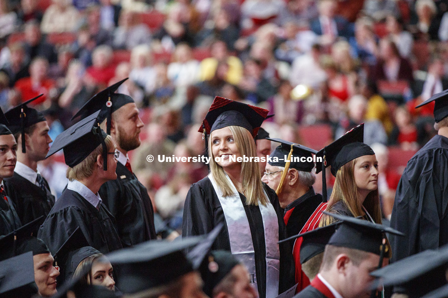 Michelle Henry looks up to her family and friends as she heads to the stage at the Undergraduate Commencement in Pinnacle Bank Arena. December 15, 2018. Photo by Craig Chandler / University Communication.