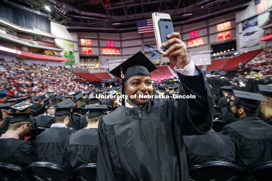 Ahmed Al Yaqoubi takes a panoramic video after receiving his degree Saturday morning at the Undergraduate Commencement in Pinnacle Bank Arena. December 15, 2018. Photo by Craig Chandler / University Communication.