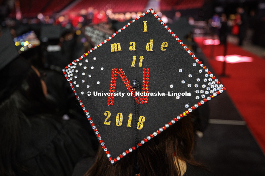 A decorated mortarboard at the Undergraduate Commencement in Pinnacle Bank Arena. December 15, 2018. Photo by Craig Chandler / University Communication.