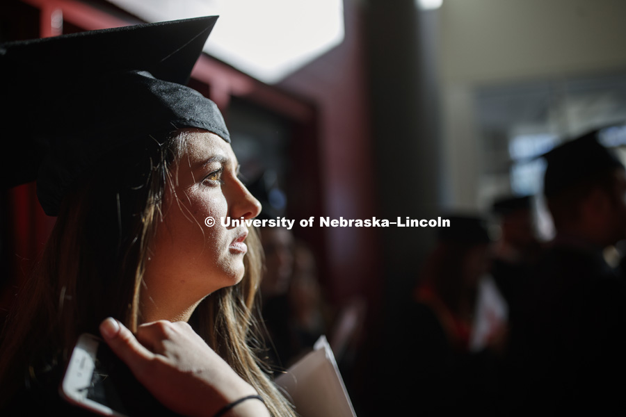 Nicole Madison waits for her family and friends after commencement. Undergraduate Commencement in Pinnacle Bank Arena. December 15, 2018. Photo by Craig Chandler / University Communication.