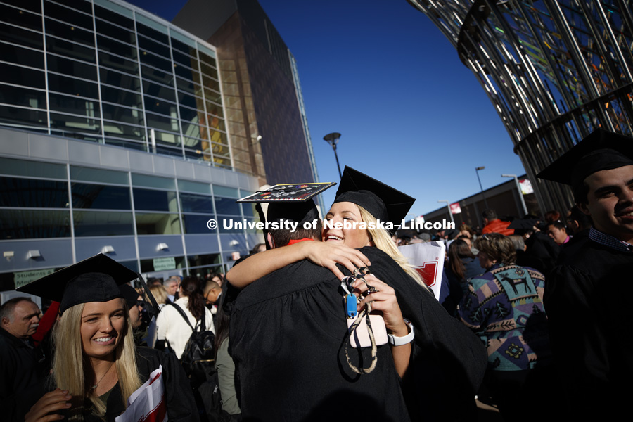 Ross Rogers and Laine Swift share a hug outside Pinnacle Bank Arena after commencement. December 15, 2018. Photo by Craig Chandler / University Communication.