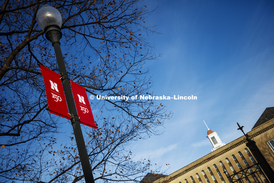 New banners to celebrate the university's 150th anniversary are being hung on campus. December 18, 2018. Photo by Craig Chandler / University Communication.
