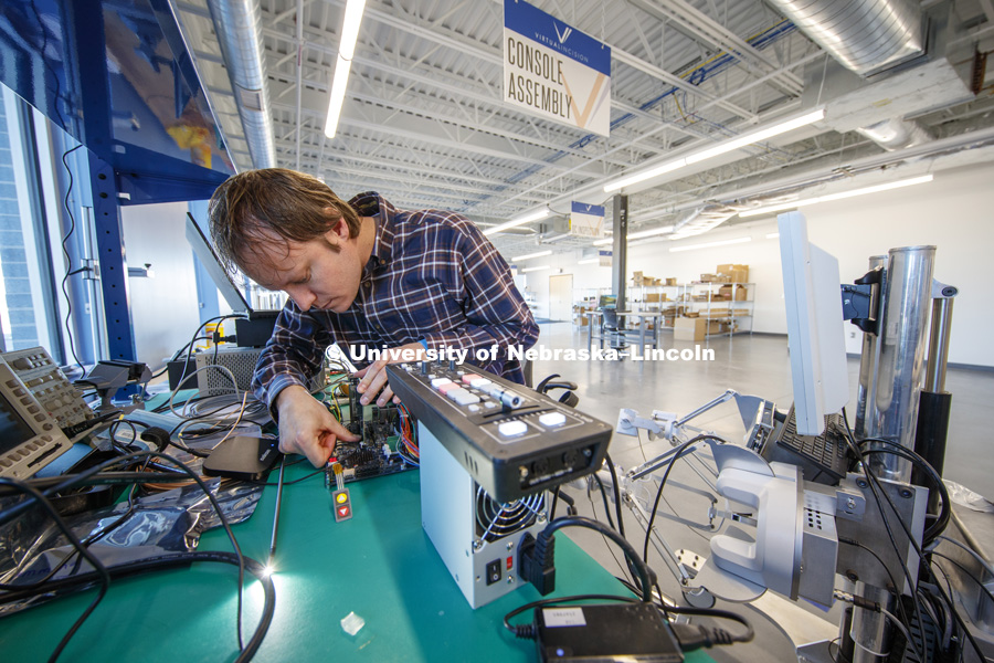 Jason Dumpert works with components in the console assembly area. Virtual Incision has relocated to the newest building on Nebraska Innovation Campus and expanded their footprint to include manufacturing areas for the surgical robots. December 20, 2018. Photo by Craig Chandler / University Communication.