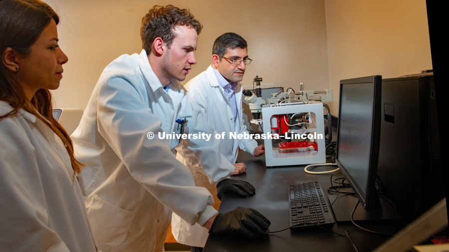 Ali Tamayol (far right), Assistant Professor of Engineering, with doctoral students Azadeh Mostafavi (left) and Jacob Quint pictured in lab. January 7, 2019. Photo by Greg Nathan, University Communication.
