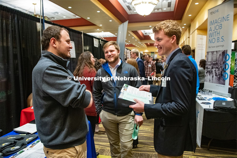 Jared Muhlbach and Carson Hicks talk with a recruiter from Farmers Cooperative at the STEM Career Fair (Science, Technology, Engineering, and Math) in Embassy Suites. Sponsored by Career Services. February 12, 2019. Photo by Gregory Nathan / University Communication.