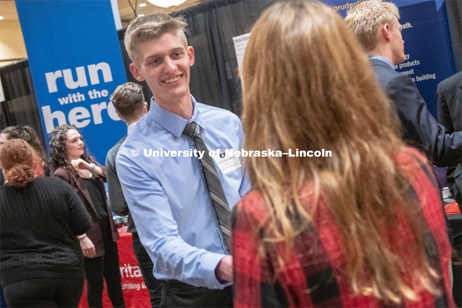 Ryan Soderquist speaks with a recruit at the STEM Career Fair (Science, Technology, Engineering, and Math) at Embassy Suites. Sponsored by Career Services. February 12, 2019. Photo by Gregory Nathan / University Communication.