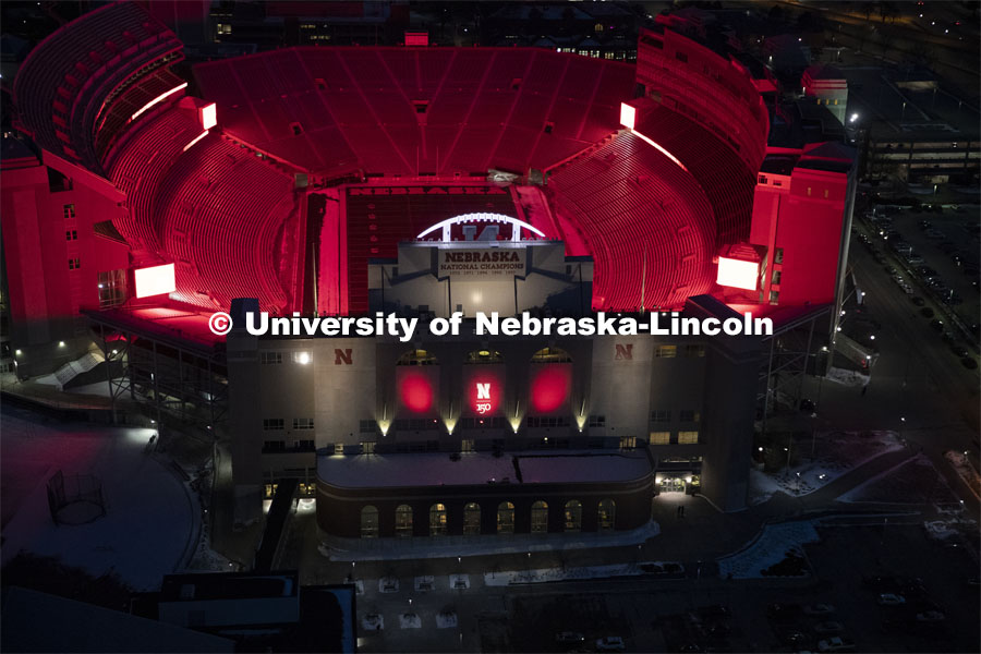 Memorial Stadium is a big red anchor to the colorful city campus Thursday night. Glow Big Red bathes the campuses with red lights as part of N150's Charter Week celebration. February 14, 2019. Photo by Craig Chandler / University Communication.