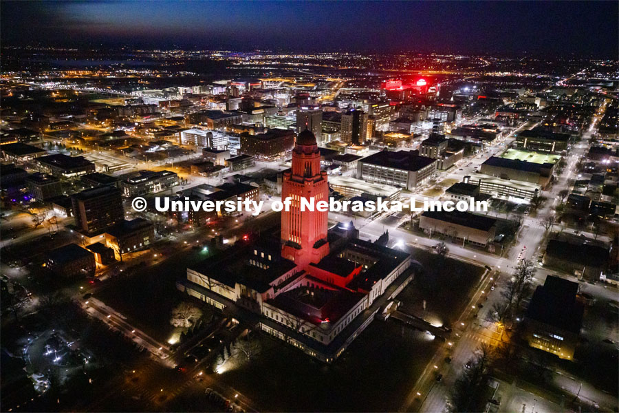 The Capitol glows red with the university to the above right in the photo. Glow Big Red bathes the campuses with red lights as part of N150's Charter Week celebration. February 14, 2019. Photo by Craig Chandler / University Communication.