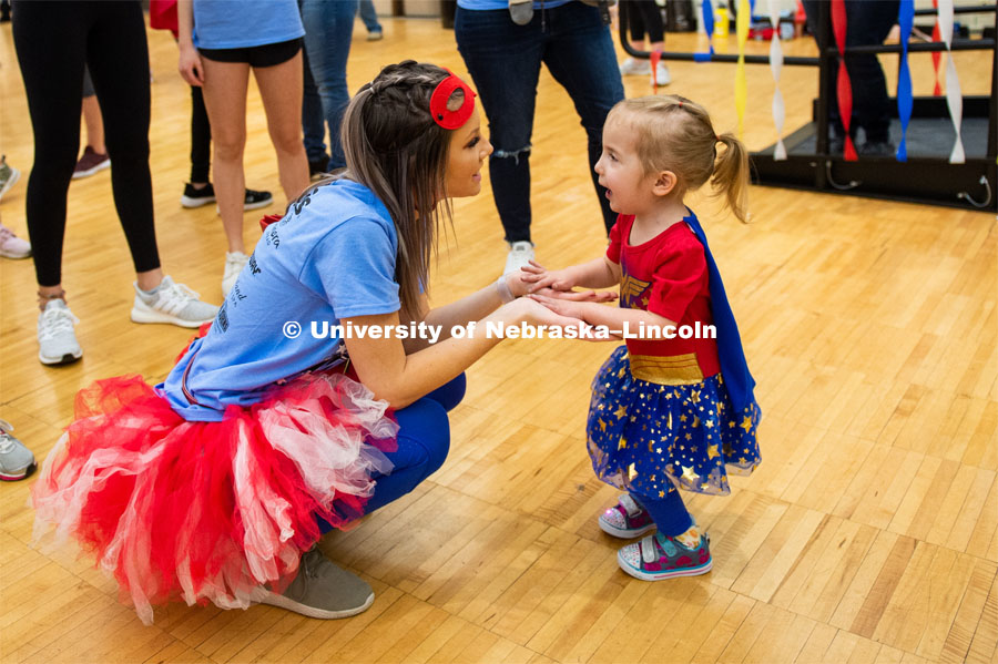 Student engaging with miracle child dressed as Wonder Woman. 1274 Nebraska students signed up to be part of the Huskerthon Dance Marathon for Children's Hospital in Omaha. February 16, 2019. Photo by Justin Mohling / University Communication.
