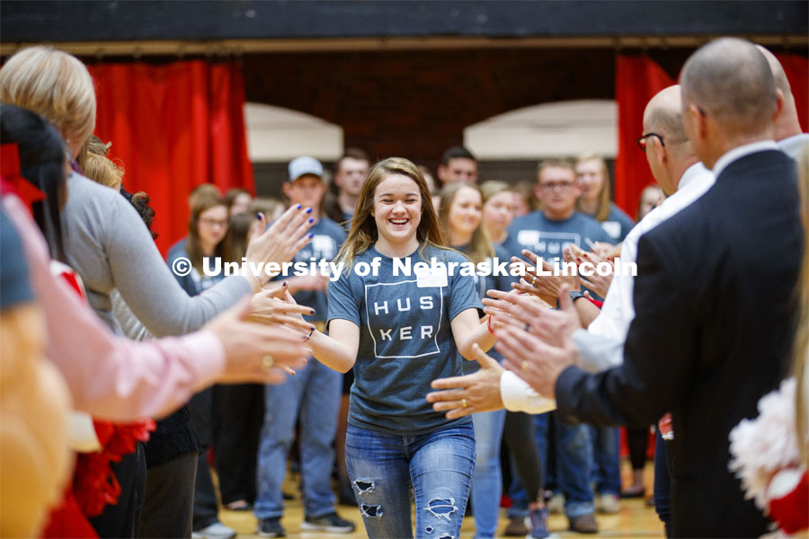 Madison Nuss runs through a tunnel walk of high-fives at the FFA signing ceremony for current senior FFA members who have committed to Nebraska. April 3, 2019. Photo by Craig Chandler / University Communication.