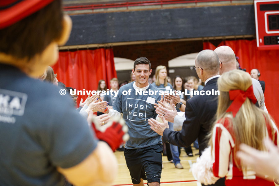 Seth George runs through a tunnel walk of high-fives at the FFA signing ceremony for current senior FFA members who have committed to Nebraska. April 3, 2019. Photo by Craig Chandler / University Communication.