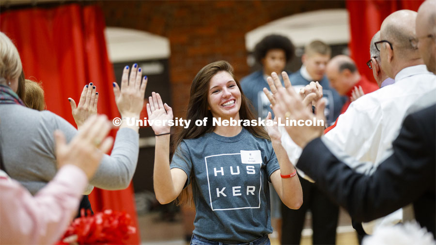 Bryn Hannan runs through a tunnel walk of high-fives at the FFA signing ceremony for current senior FFA members who have committed to Nebraska. April 3, 2019. Photo by Craig Chandler / University Communication.