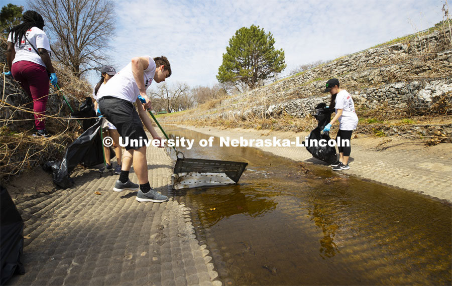 Alec Skinner pulls debris from Deadman's Run as teams worked to clean up trash in the run east of East Campus. More than 2,500 University of Nebraska–Lincoln students, faculty and staff volunteered for the Big Event on April 6, completing service projects across the community. Now in its 13th year at Nebraska, the Big Event has grown to be the university's single largest student-run community service project. April 6, 2019. Photo by Craig Chandler / University Communication.