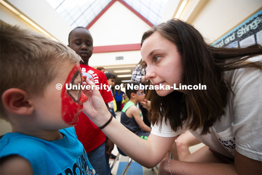 Grace Wilson concentrates on her face painting as she and others from Gamma Phi Beta helped with the Campbell Elementary School Carnival. More than 2,500 University of Nebraska–Lincoln students, faculty and staff volunteered for the Big Event on April 6, completing service projects across the community. Now in its 13th year at Nebraska, the Big Event has grown to be the university's single largest student-run community service project. April 6, 2019. Photo by Craig Chandler / University Communication.