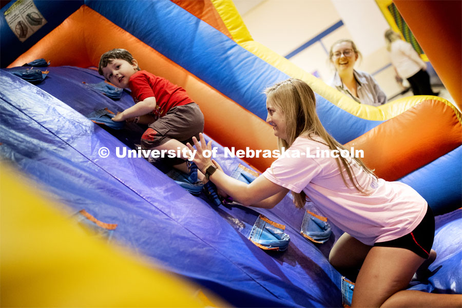 Emma Vertin helps a youngster make it up a climbing ramp in an inflatable maze. She and others from Gamma Phi Beta helped with the Campbell Elementary School Carnival. More than 2,500 University of Nebraska–Lincoln students, faculty and staff volunteered for the Big Event on April 6, completing service projects across the community. Now in its 13th year at Nebraska, the Big Event has grown to be the university's single largest student-run community service project. April 6, 2019. Photo by Craig Chandler / University Communication.